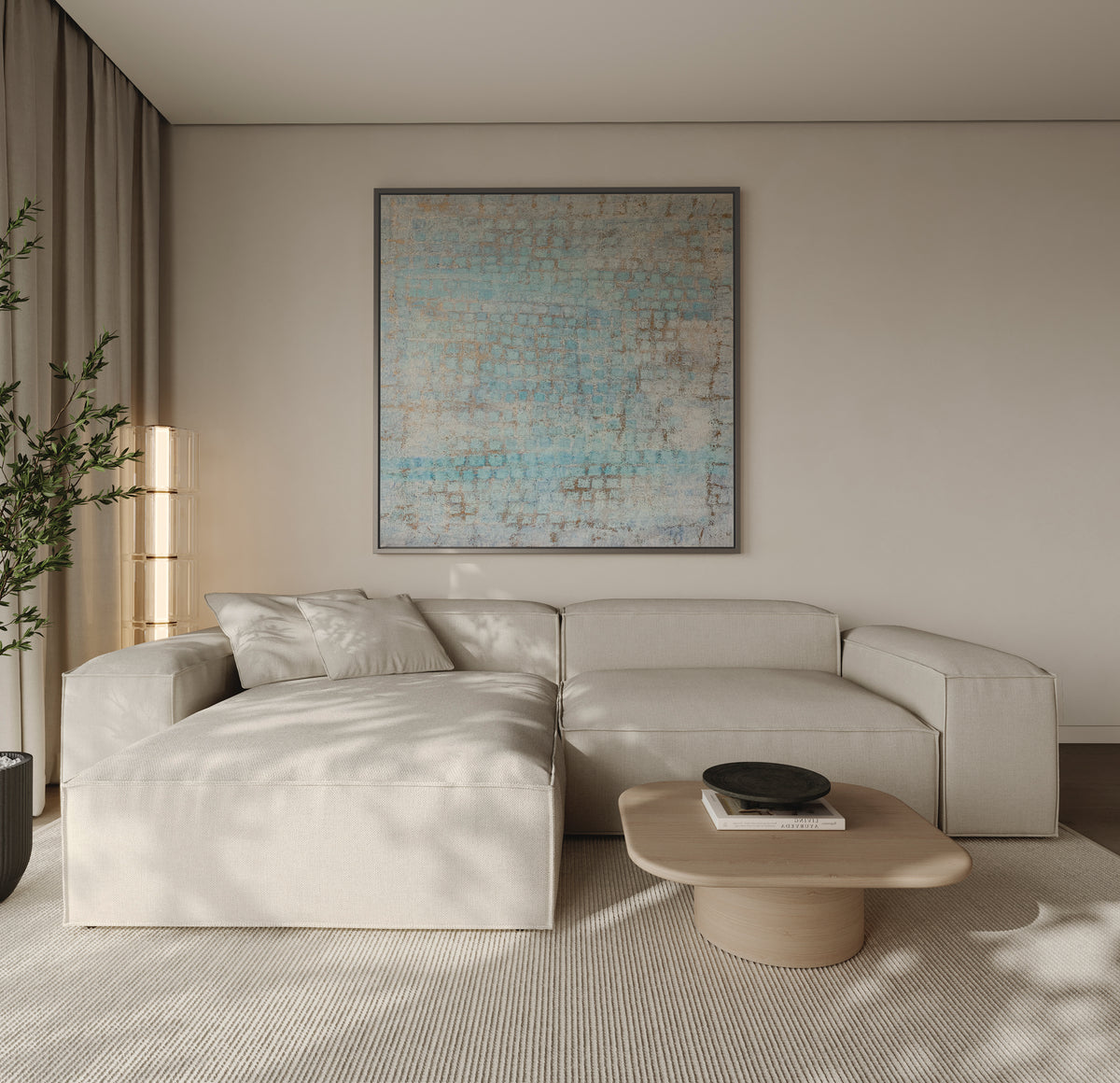 Modern living room with a framed canvas art print with a quiet coastal abrstract look above a beige sectional sofa, coffee table. Contemporary abstract canvas wall art collection by Art Collectiv. Credits: ©2019 Nadée / Artmajeur.com x Art Collectiv