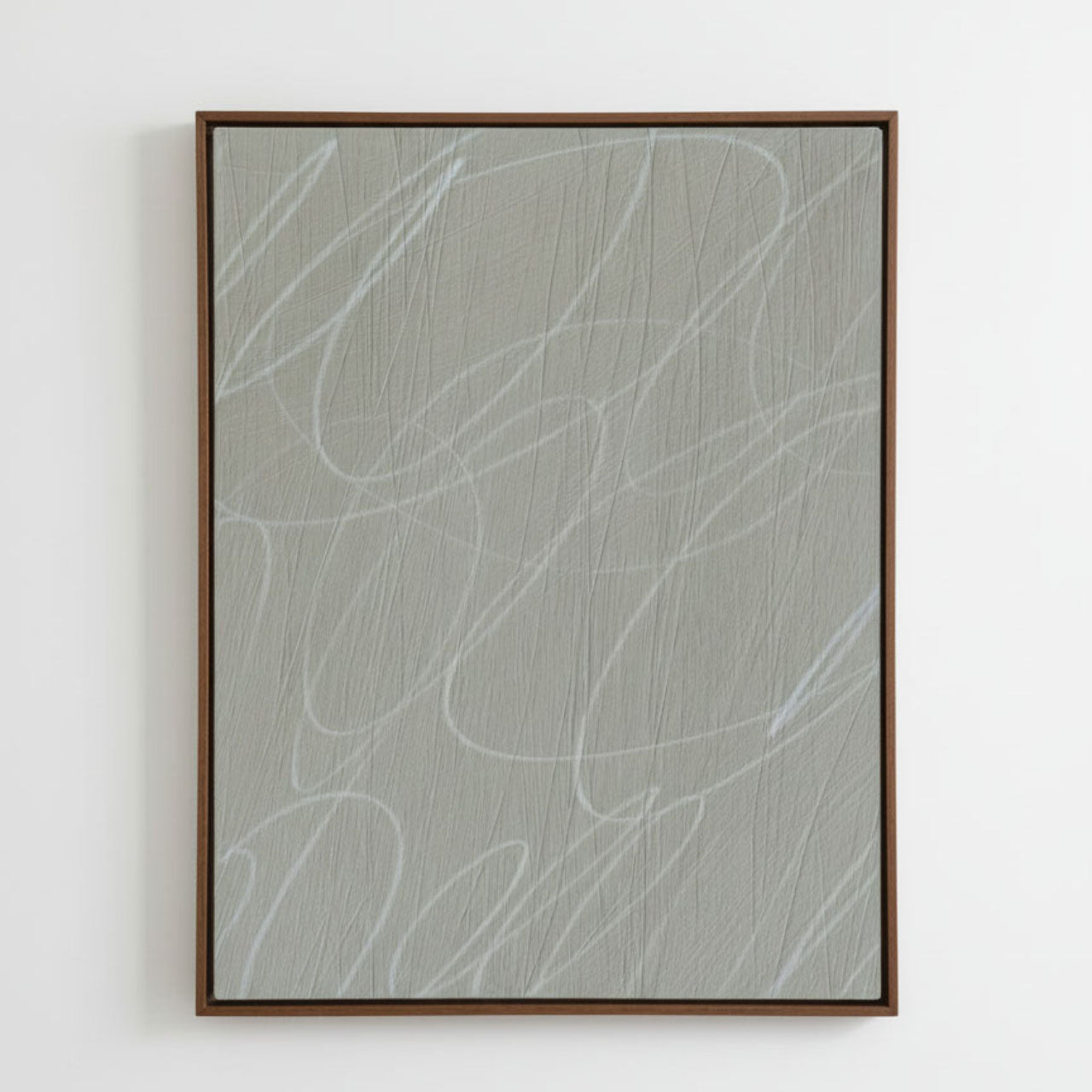 Framed abstract artwork with light gray/greige background and white gestural lines in a natural dark wood frame