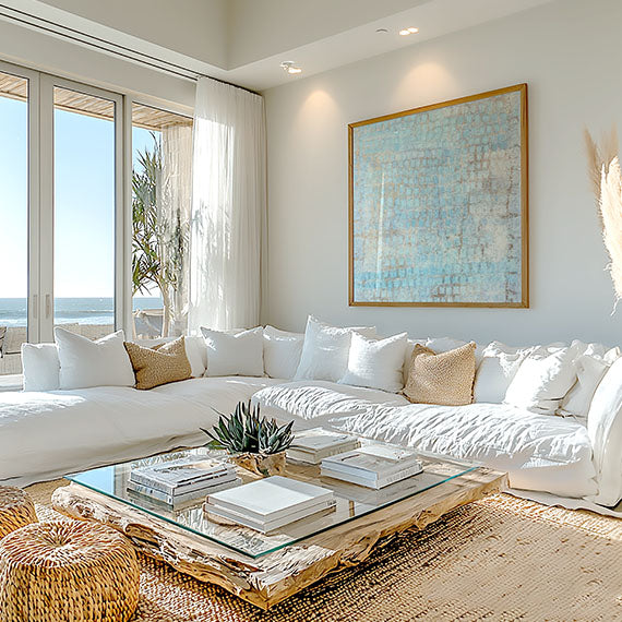 Coastal blue framed art print above a modern casual sofa, beach coastal interior. Quiet coastal. Credits: ©2019 Nadée / Artmajeur.com x Art Collectiv