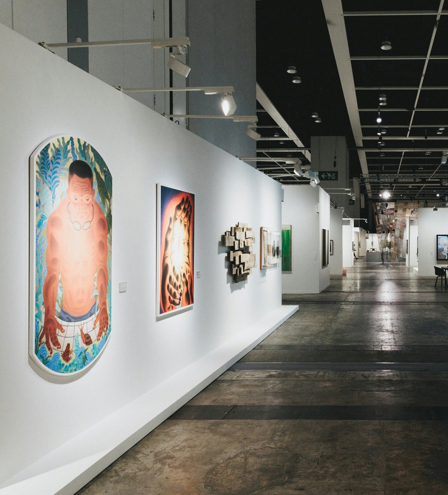 Art fair with various artworks on white walls. Photo by Spencer Chow on Unsplash.
