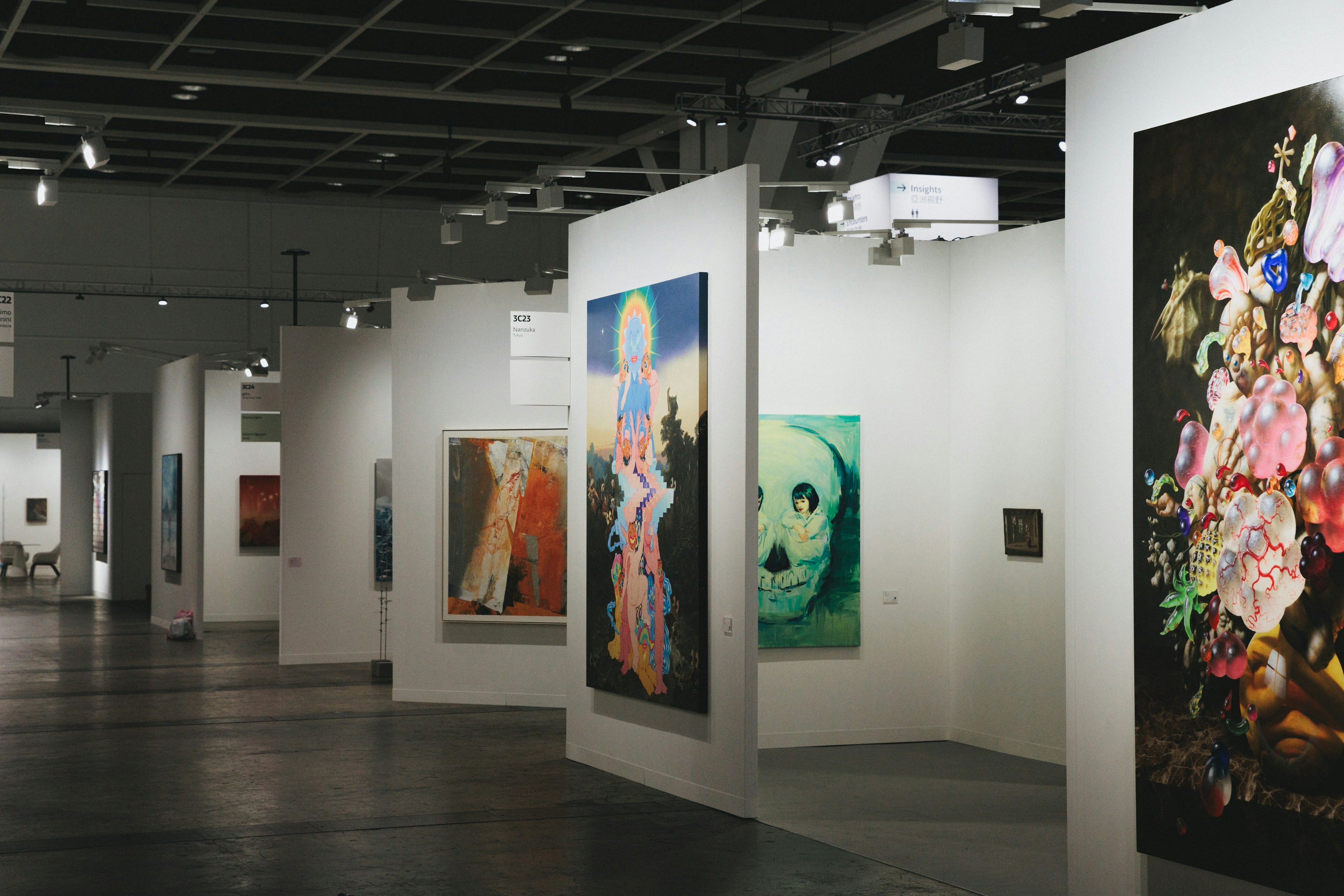 Art fair with art galleries and various artworks on display,  Photo by Spencer Chow on Unsplash.